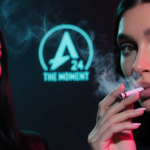Kylie Jenner exhaling cigarette smoke with Charli xcx posing opposite and A24 logo glowing in neon-lit backdrop