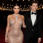 Kylie Jenner posing on red carpet with diamond necklace and Timothée Chalamet beside her