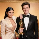 Kylie Jenner stands with Timothée Chalamet holding his Golden Globe Award with Hollywood glamour backdrop