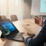 Person gestures during meeting with Lenovo ThinkBook Plus Auto Twist laptop screen rotated toward them and blurred whiteboard