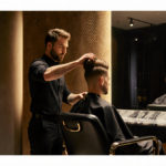 Chris Appleton resting hand on celebrity client with luxurious hair and golden salon light