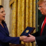 Maria Corina Machado presenting Nobel Peace Prize to Donald Trump with warm golden White House lighting and clasped hands