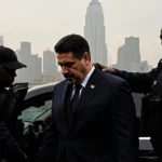 Venezuelan president Maduro stepping out of black SUV with Secret Service agents and misty Manhattan skyline behind