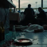 Police investigate Manchester crime scene with shattered glass and bloodstain on plate near motionless customer