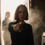 Maya Hawke gestures emphatically while explaining a plot hole with steam swirling around her and Robin visible behind