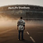 Lone fan stands in empty MetLife Stadium parking lot with fading jersey and golden sunset casting long shadows