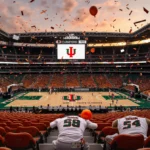 Packed stadium celebrates championship with Miami Hurricanes logo on screen and confetti filling the air