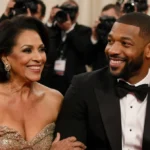 Michael B. Jordan and his mother Donna share a warm smile on the red carpet with paparazzi behind them