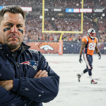 Mike Vrabel stands alone with arms crossed with Patriots logo on jacket in snowy championship backdrop and Broncos walking aw