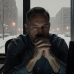 Paul Allen apologizes in a quiet radio studio with a faint monitor glow and foggy windows reflecting snow.