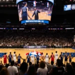 Diverse basketball fans holding hands and cheering together with giant screen showing NBA games and NBC logo behind them