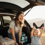 Mom laughing at car with toddler holding high heels and luggage packed for family road trip