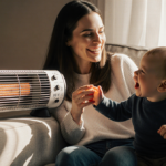 Laney Morello smiles while sitting on couch with Elio playing near a space heater cord wrapped over the corner warm light fam