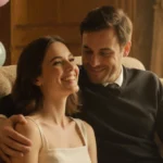 Natalie Lock smiling on couch with Drew