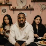 Ne-Yo relaxing in cozy living room with three women reading guitar and cooking dinner