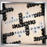 Bold crossword letters connect in grid with silver frame showing Across answers and floating Down words glowing with warm lig