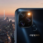 Oppo Find X9 Pro camera lens glowing with warm golden light and case on top with cityscape at dusk in background