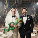 Paul Rudd and Jack Black hold a giant novelty snake puppet with ridiculous wedding attire and chaotic film set.