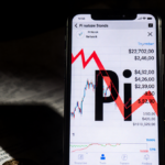 Smartphone screen shows Pi Network logo with red zero overlay with shadow and falling stock graph behind and coins scattered