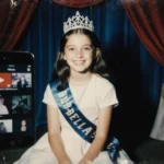 Young girl in tiara poses on miniature stage with troubled eyes and faint phone screen showing YouTube videos behind her