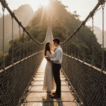Onnie Jules Martinez kneeling with ring box in hand while girlfriend embraces him on bamboo bridge