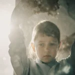 Person typing on computer with coffee and notebook on desk