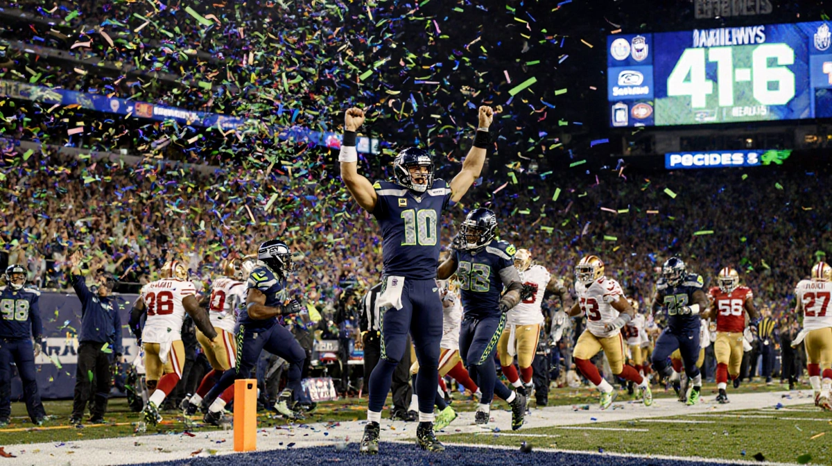 Seahawks quarterback Geno Smith celebrating touchdown with arms raised as teammates rush over with confetti falling and score