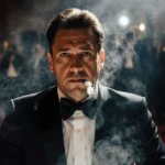 Sean Penn sits alone with cigarette smoke swirling around him and spotlight illuminating his defiant expression