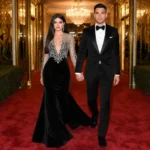 Selena Gomez and Benny Blanco walk hand-in-hand at the Golden Globes with her black beaded gown and his tuxedo glowing under