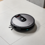 Shark Matrix Plus robot vacuum and mop cleans a sleek wood floor with subtle dust and metallic surface and Lidar navigation