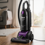 Vacuum cleaner centered on hardwood floor with natural light top left and detachable wand extended and HEPA filter visible