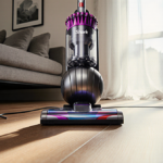 Shark vacuum lying open on hardwood floor with natural light illuminating its metallic body