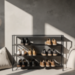 Shoes displayed neatly on minimalist rack with warm lighting and cozy throw pillows.