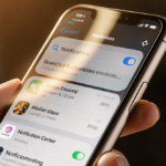 Smartphone screen showing a muted Notification Center overlay with liquid glass tint and warm golden lighting for readability