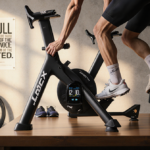 Tacx Neo 2T Smart Trainer gleams with warm lighting and motivational posters in a modern home gym.