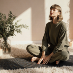 Taylor Swift presses into acupressure mat with plush floor and candles and fresh greenery