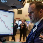 Trader staring at Tesla stock crash on flickering screen with worried investors and golden shadows