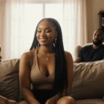 Teyana Taylor sits on couch with her children playing nearby and Iman Shumpert watching from armchair showing peaceful co-par