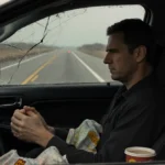 Timothy Busfield sits exhausted in worn driver