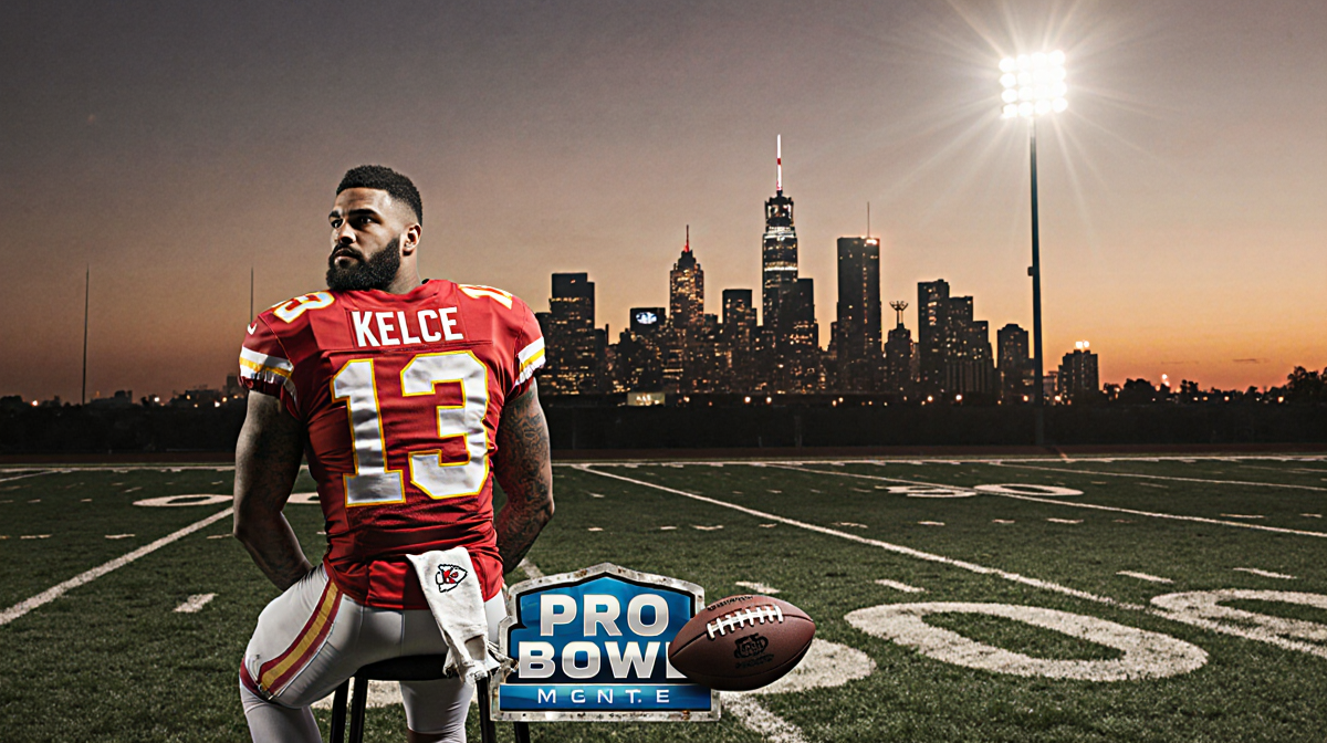 Travis Kelce stands with a football under his arm on a sunset field a spotlight highlights him over the Kansas City skyline.