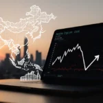 Laptop screen showing Trip.com stock ticker with falling graph lines and blurred China skyline at sunset