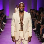 Tyson Beckford leading Ralph Lauren runway show with diverse models in purple and gold outfits