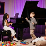 Girl playing piano with siblings dancing and baby resting on cushion in elegant living room