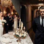 Victoria Beckham stands poised at wedding reception with guests smiling and David Beckham stands alone in dim hallway behind