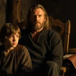 Viggo Mortensen sits in wooden chair with golden light on his face and Frodo