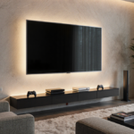 Vizio TV glows warmly in a modern living room with gaming controllers resting at its base