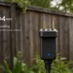 Weatherproof outdoor smart plug withstands rain with water droplets and Kasa logo on weathered surface near green plants