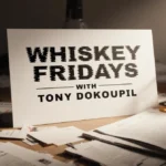 Mockup title card reading Whiskey Fridays with Tony Dokoupil sits on cluttered newsroom desk with whiskey glasses and coffee