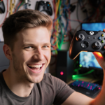Gamer proudly holding Xbox controller with gaming cables and glowing face and warm light